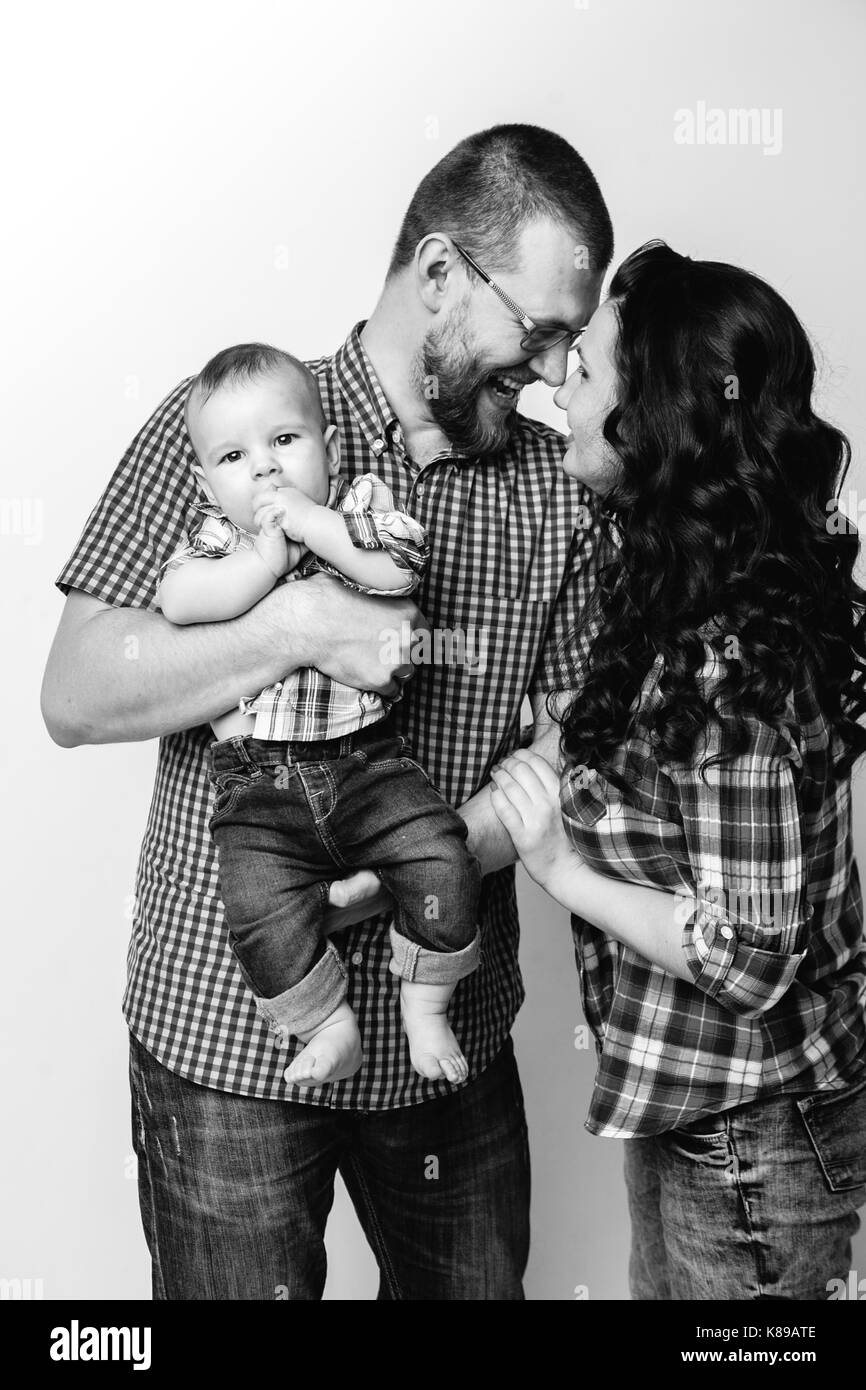 black and white portrait of young family with a baby boy Stock Photo