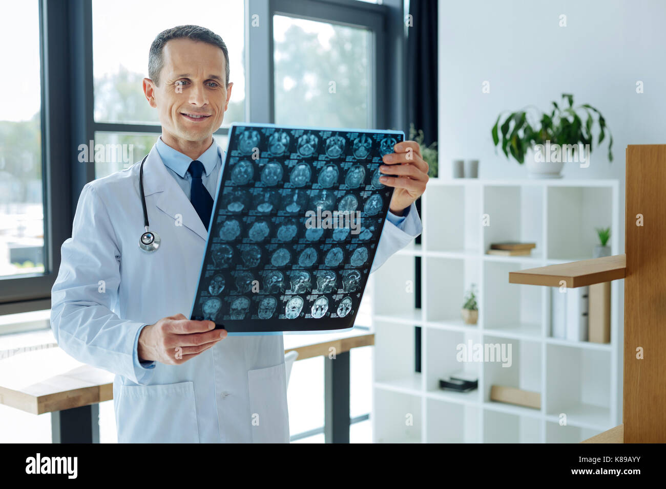 Serious professional neurologist looking at the X ray scan Stock Photo