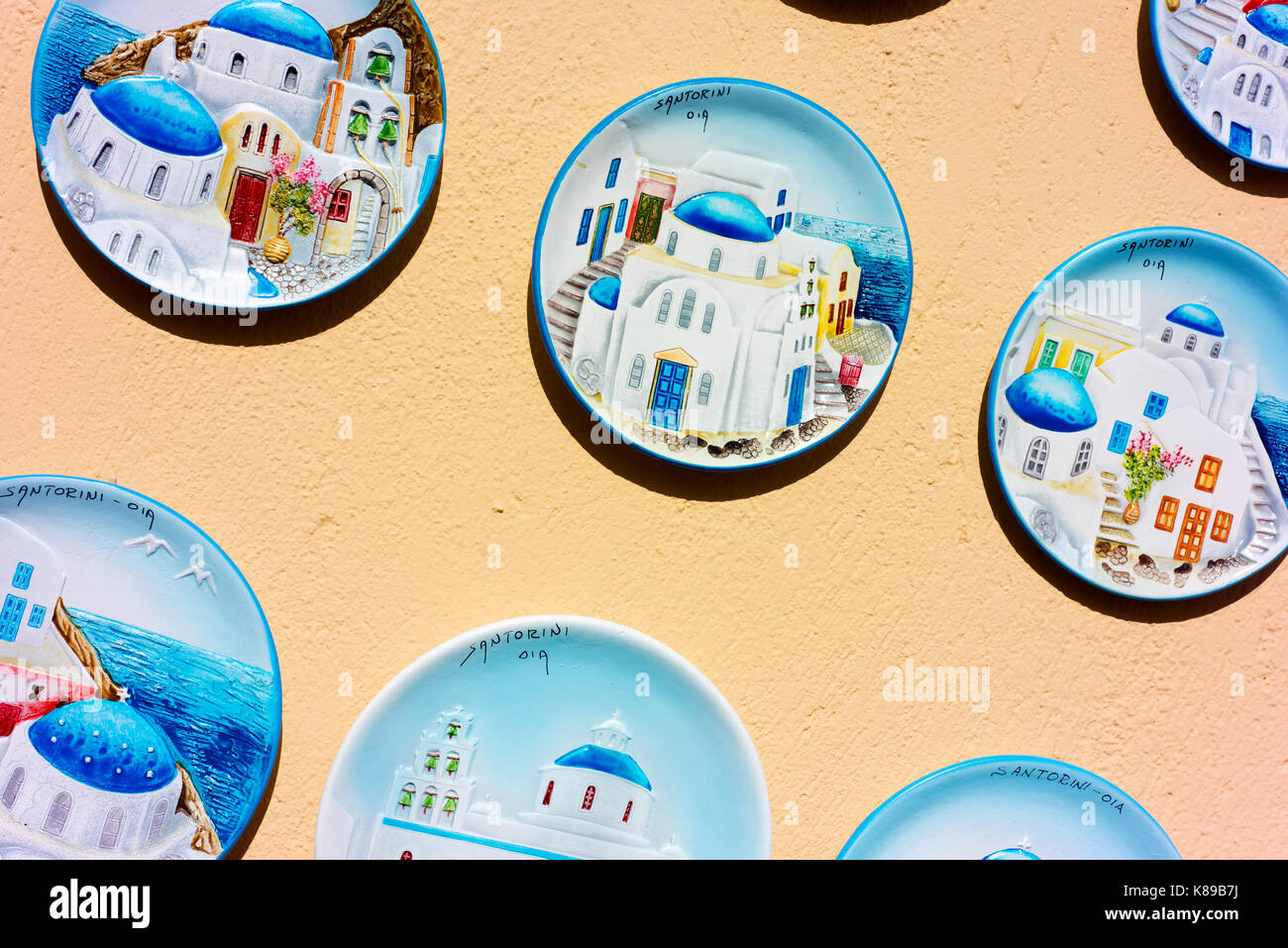 Plates decorated with Greek island scenes for sale to tourists in Fira, the main village on Santorini. Stock Photo
