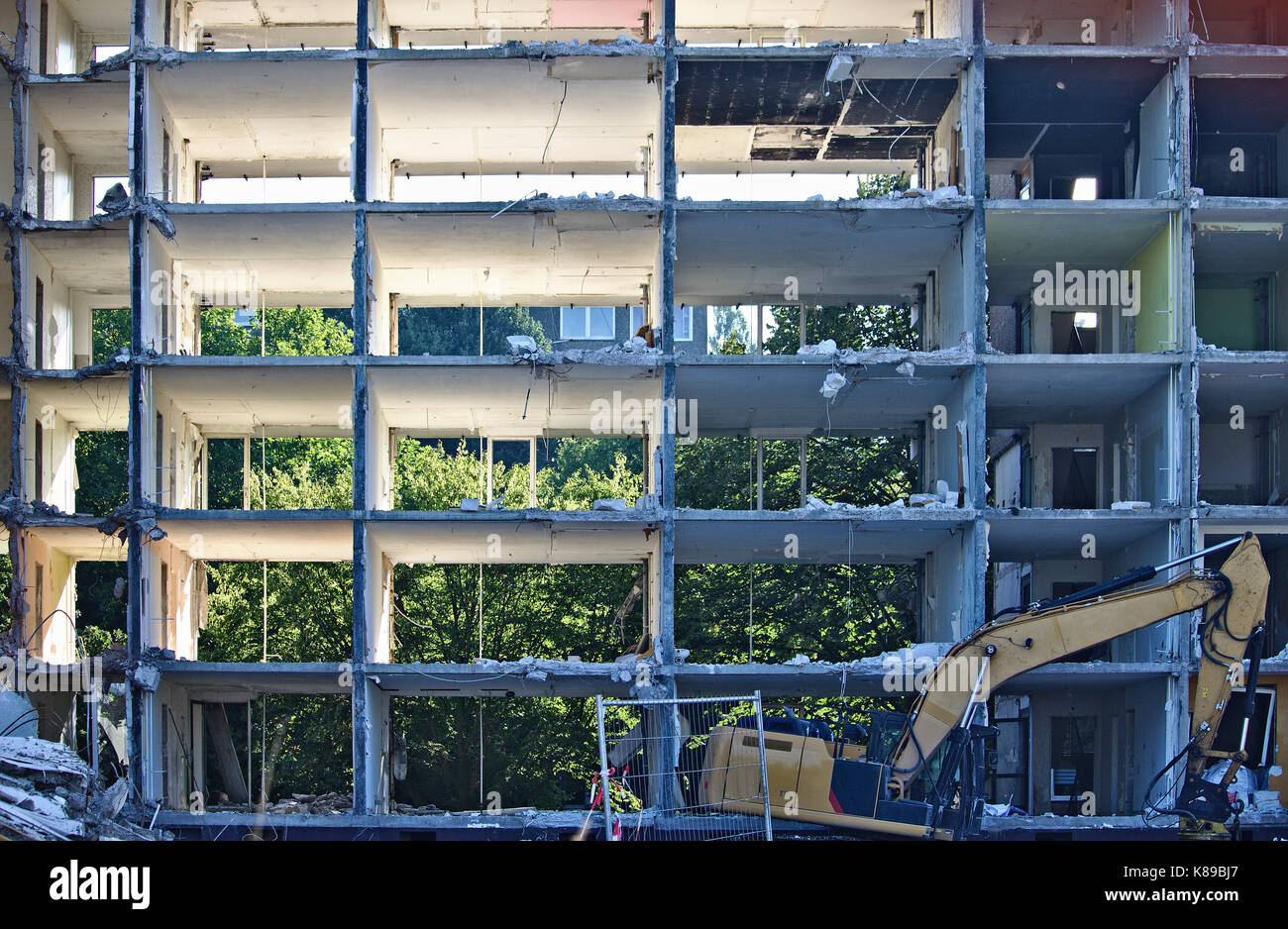 Demolished apartment building with outside walls missing Stock Photo