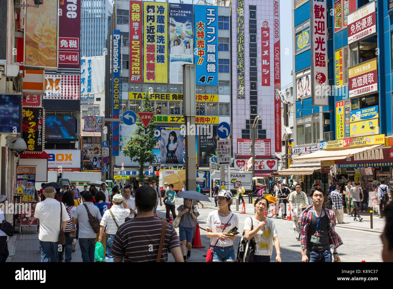 Shoppers in a street full of ads and billboards in the electronics and manga district Akihabara in Tokyo, Japan. Stock Photo