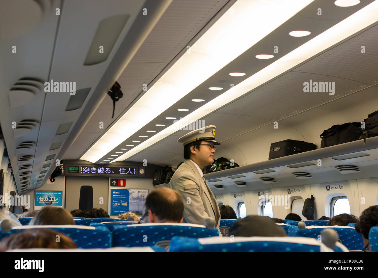 Interior shot of the Shinkansen or bullet train with a conductor during a trip between Kyoto and Tokyo, in Japan. Stock Photo