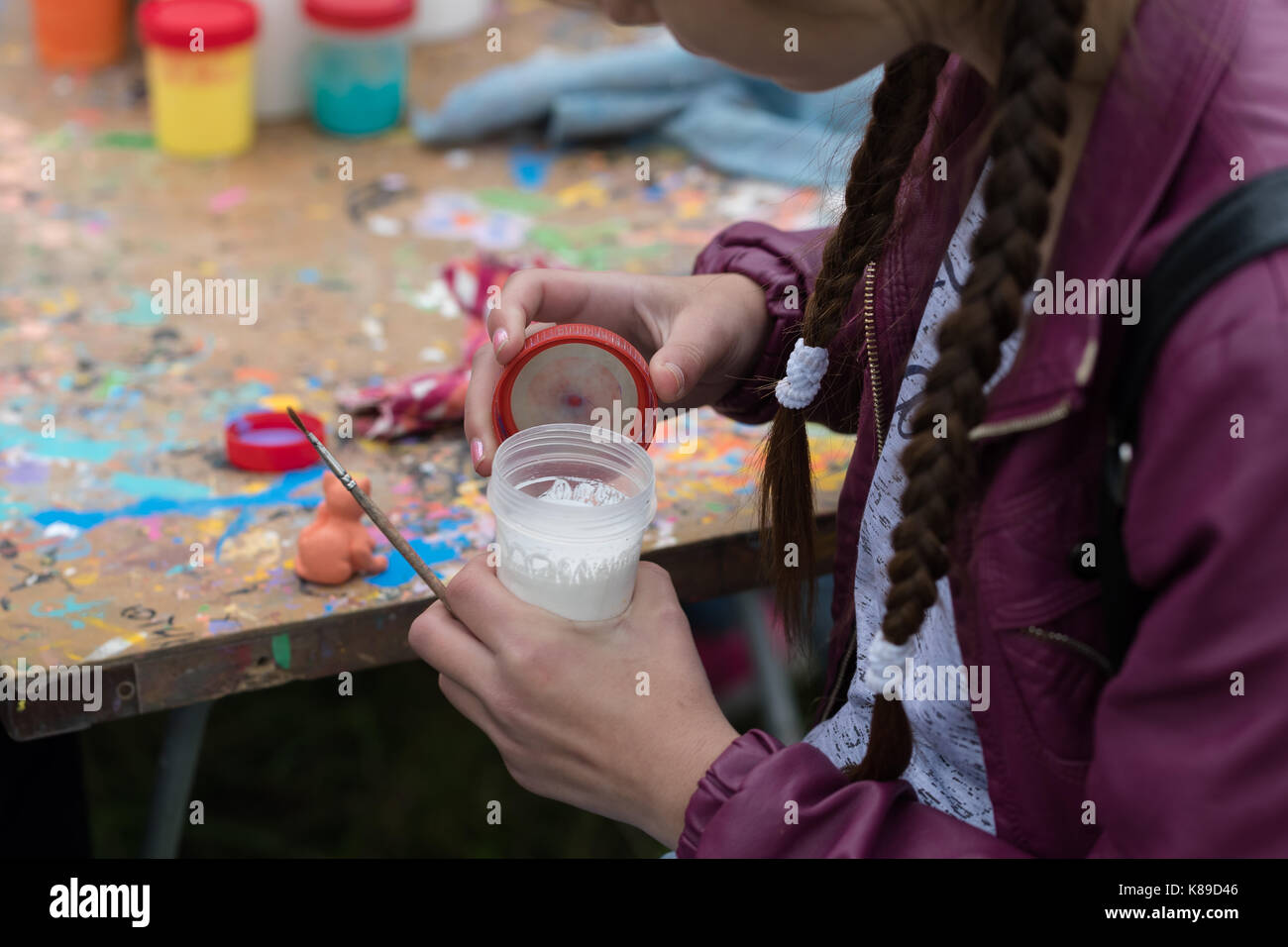 jar of paint in the hands of a young artist Stock Photo