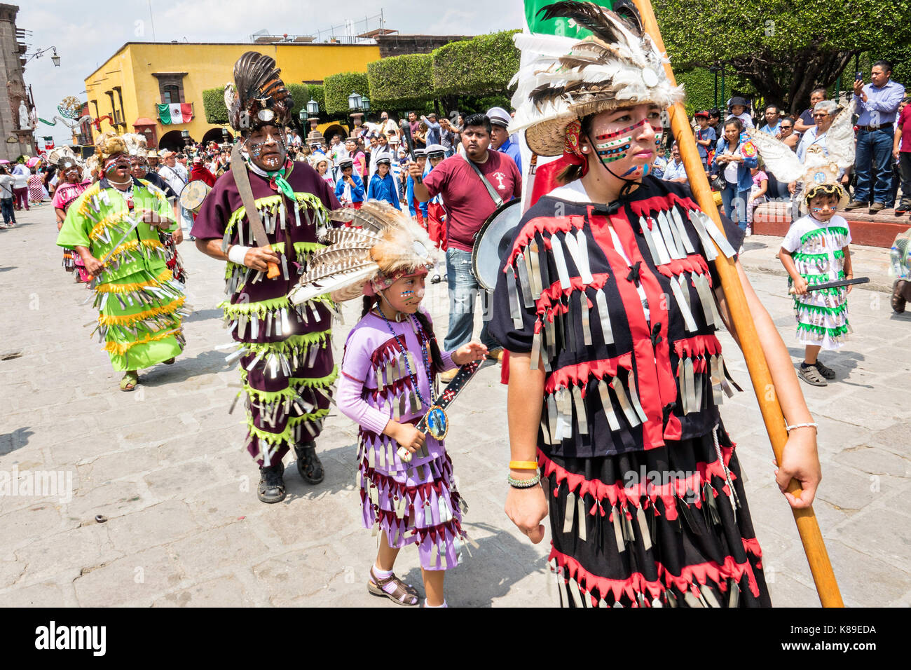 Dancers dressed as Aztec Indians process through the Jardin Allende ...
