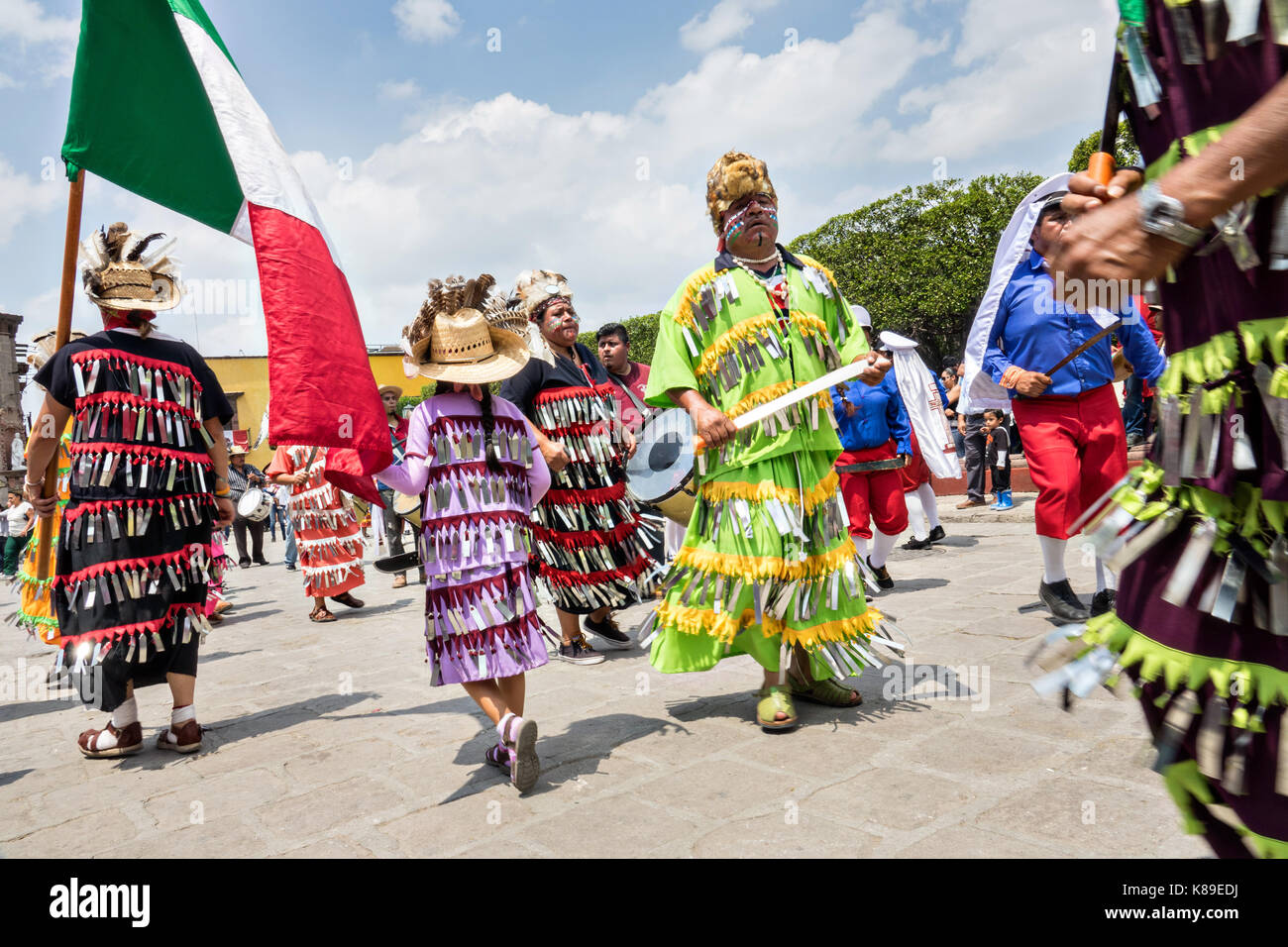 Dancers dressed as Aztec Indians process through the Jardin Allende ...