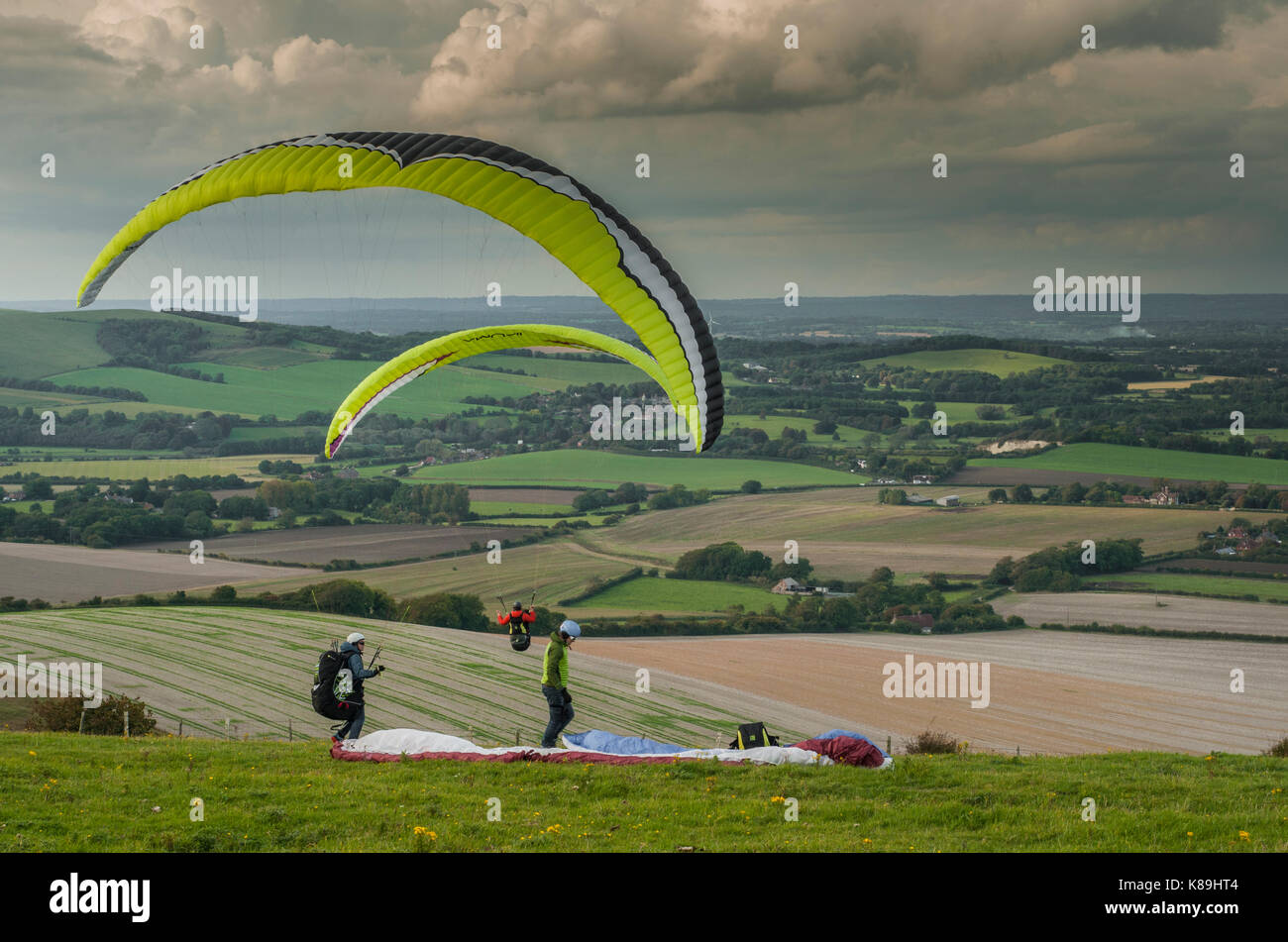 Firle Beacon, Lewes, East Sussex, UK. 18th Sep, 2017. UK Weather. Paraglider pilots on the South Downs of Southern England flying from the Beacon (Marilyn) on the Northerly wind. Scattered clouds with showers but a most pleasant afternoon. Stock Photo