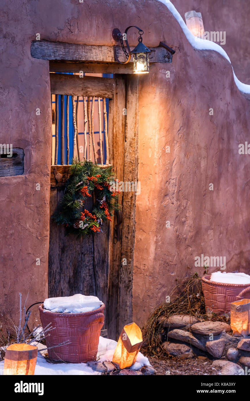 Door with Christmas wreath and farolitos, Farolito Walk, Canyon Road, Santa Fe, New Mexico USA Stock Photo