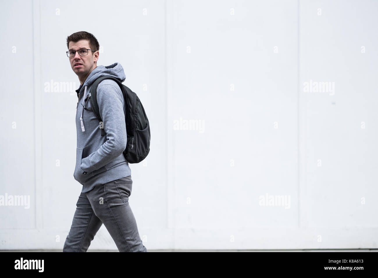 White male with back pack on London's Oxford Street Stock Photo