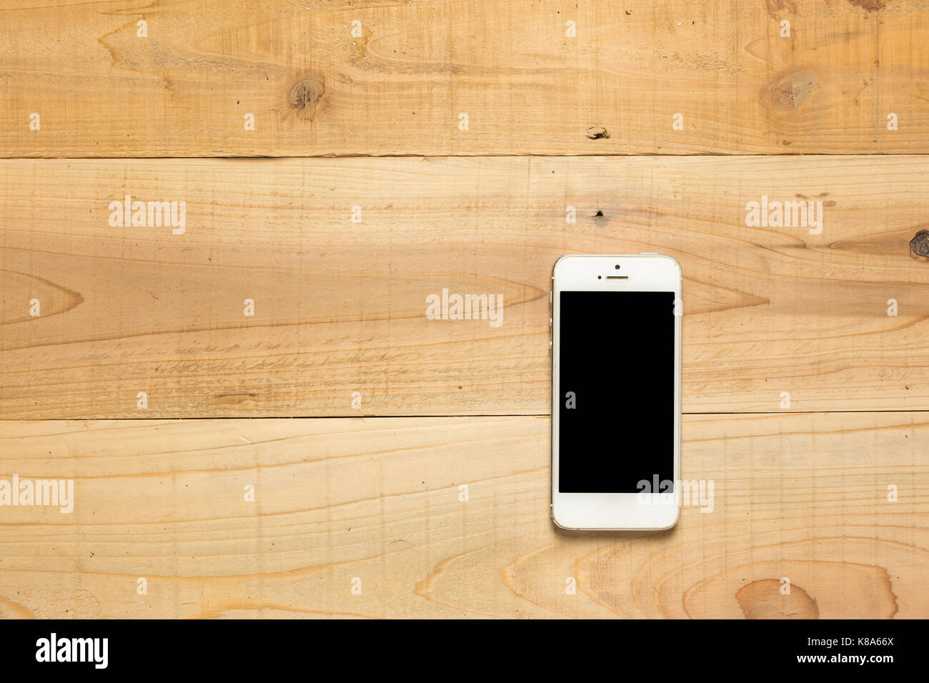 Smartphone on wooden table Stock Photo