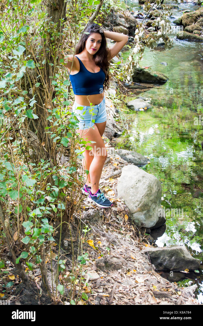 Beautiful woman in nature on the bank of a mountain river Stock Photo ...