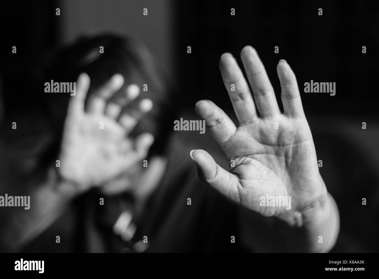 Woman with her hand extended signaling to stop (only her hand is in focus) Stock Photo