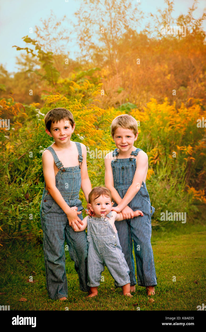 three boys wearing overalls Stock Photo - Alamy