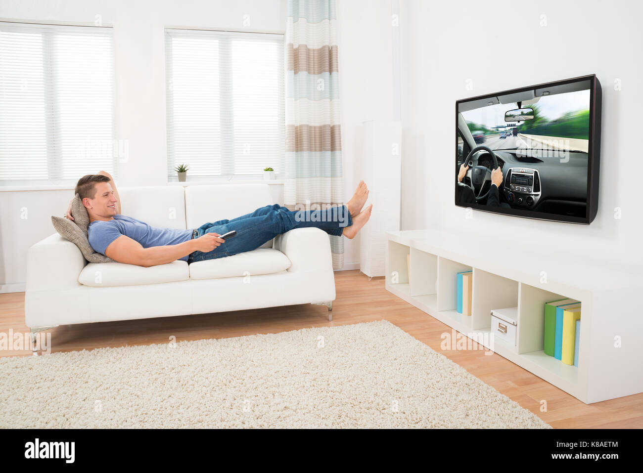 Young guy sitting home barefoot hi-res stock photography and images - Alamy
