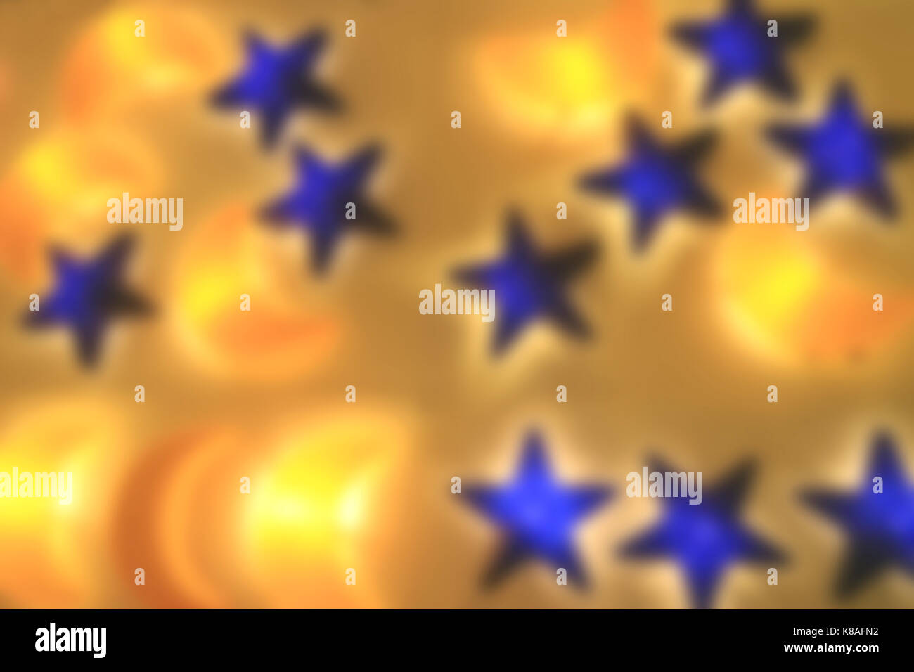 Out Of Focus Yellow Crescent Moon Shaped and Blue Star Shaped Lamps Shining on the Wall Stock Photo