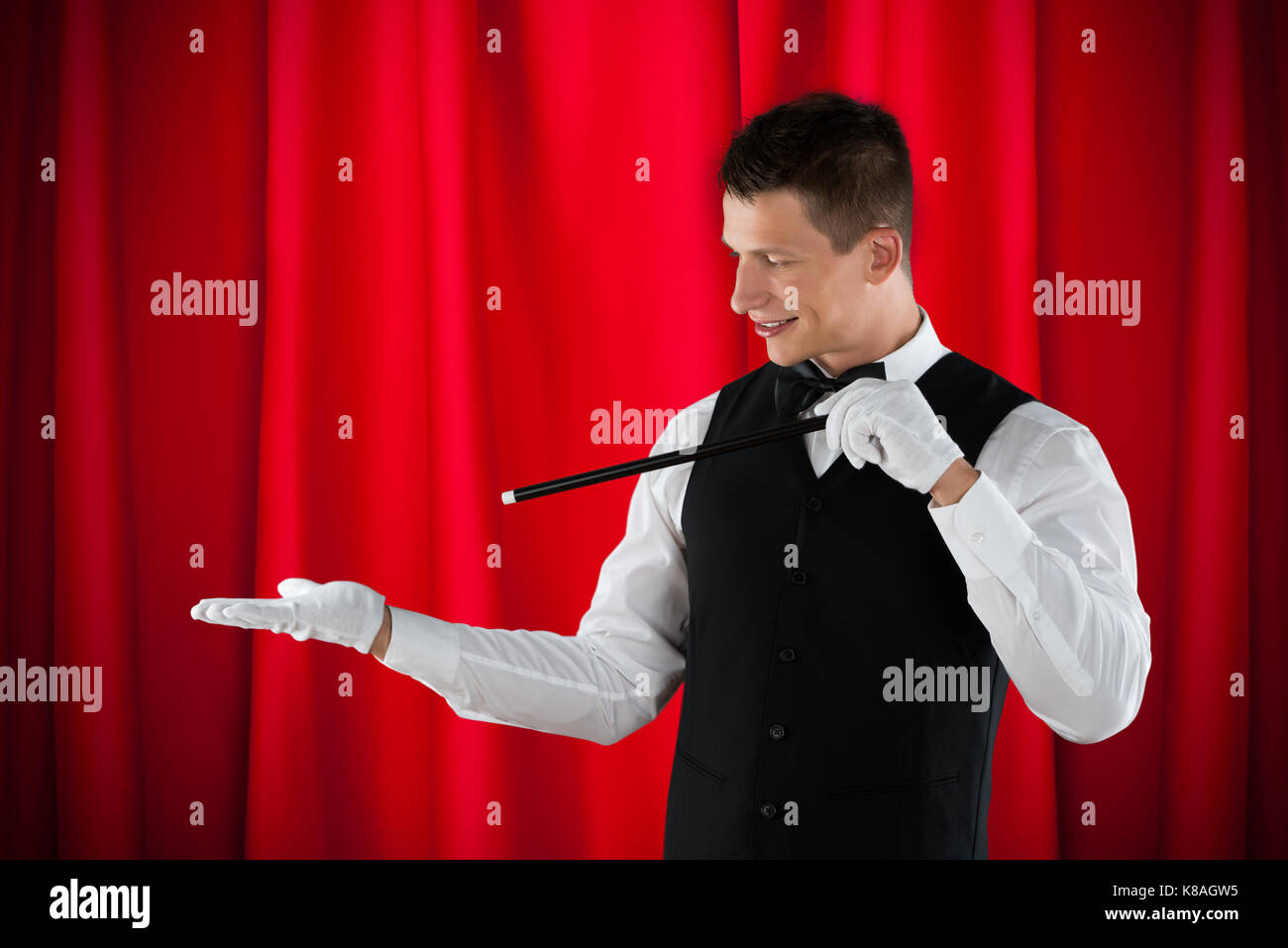 Portrait Of Young Happy Magician Performing Magic Stock Photo