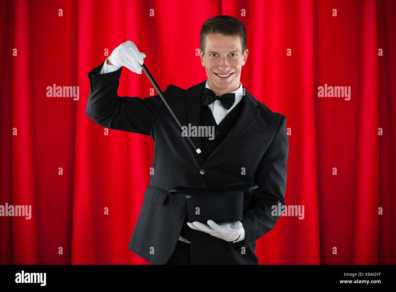Young Happy Magician Showing Magic Trick With Hat Stock Photo