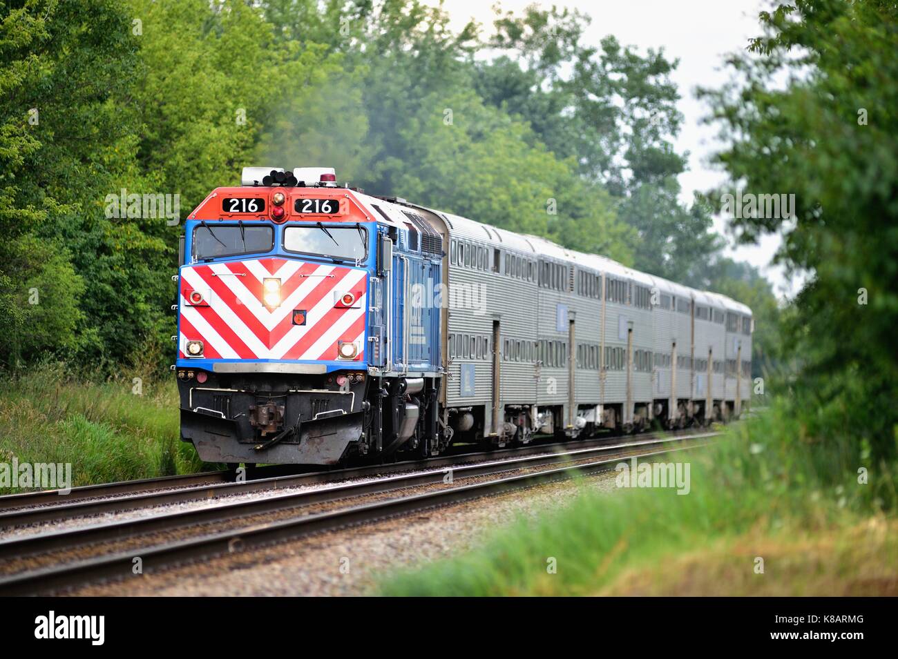 A westbound Metra train transporting commuters from Chicago through suburban Bartlett, Illinois., USA. Stock Photo