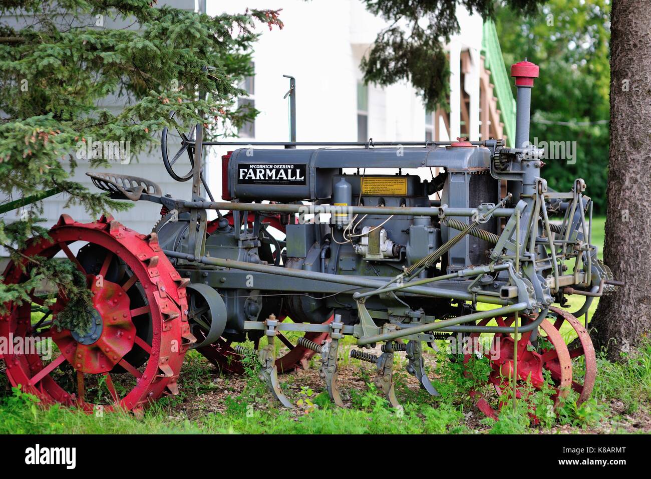 A vintage tractor relegated to non use among grass and weeds in LaFox, Illinois, USA. Stock Photo