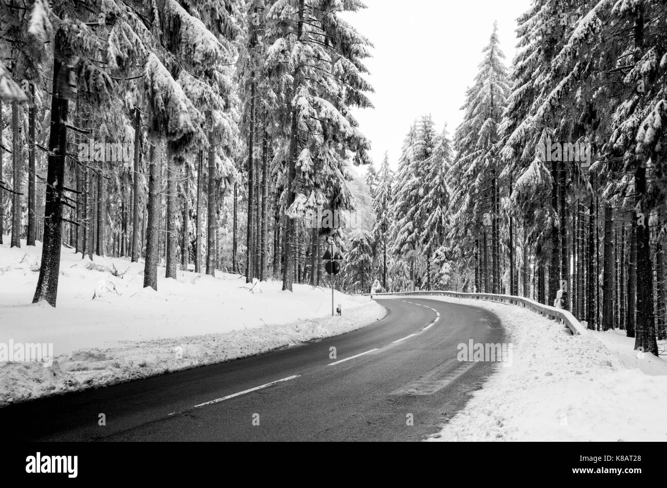 Winter Forest Road - Mountain Road Covered by Snow. Winter Theme. Winter landscape. Stock Photo