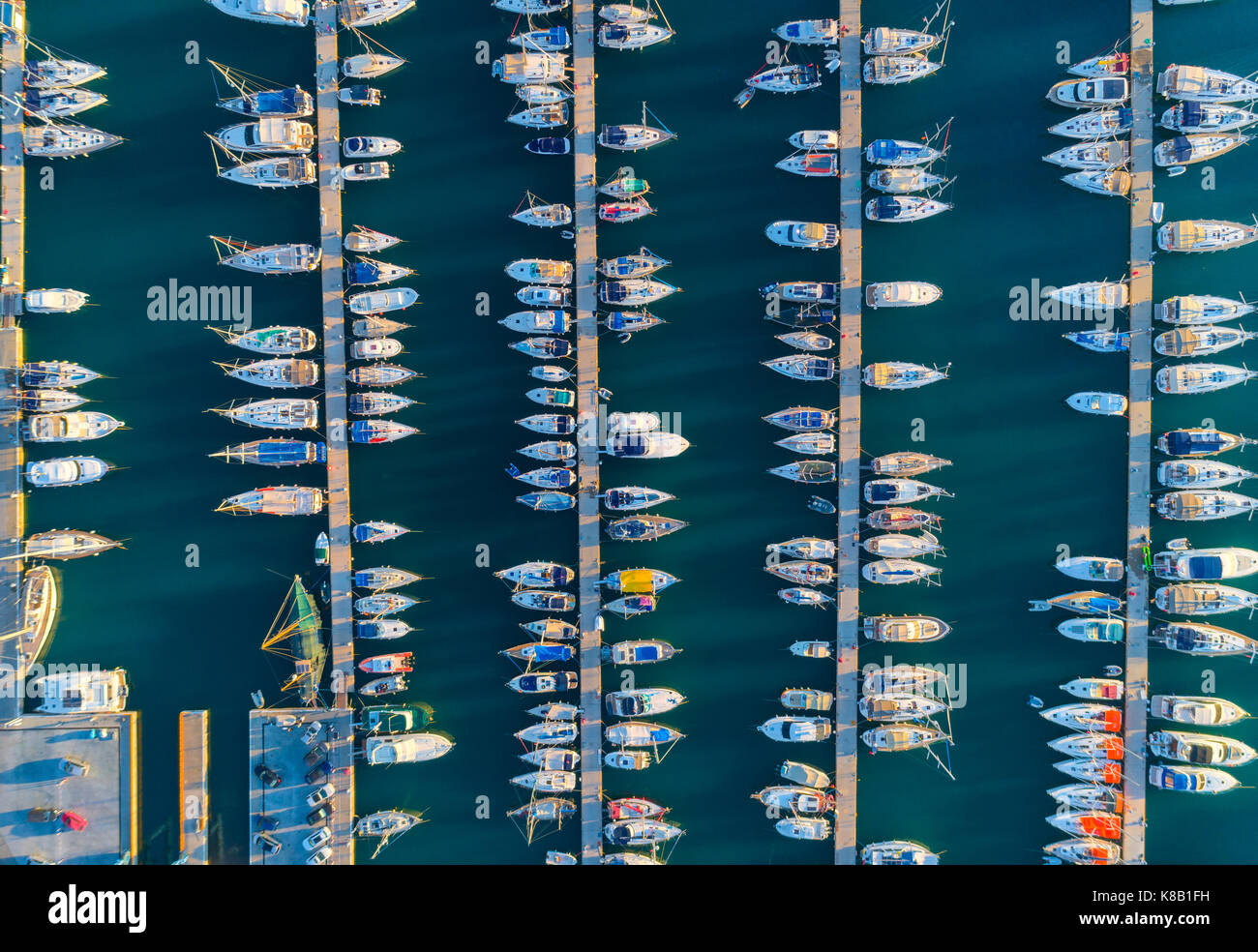 Aerial view of amazing boats at sunset in Marmaris, Turkey. Minimalistic landscape with boats and sea in marina bay. Top view from drone of harbor wit Stock Photo