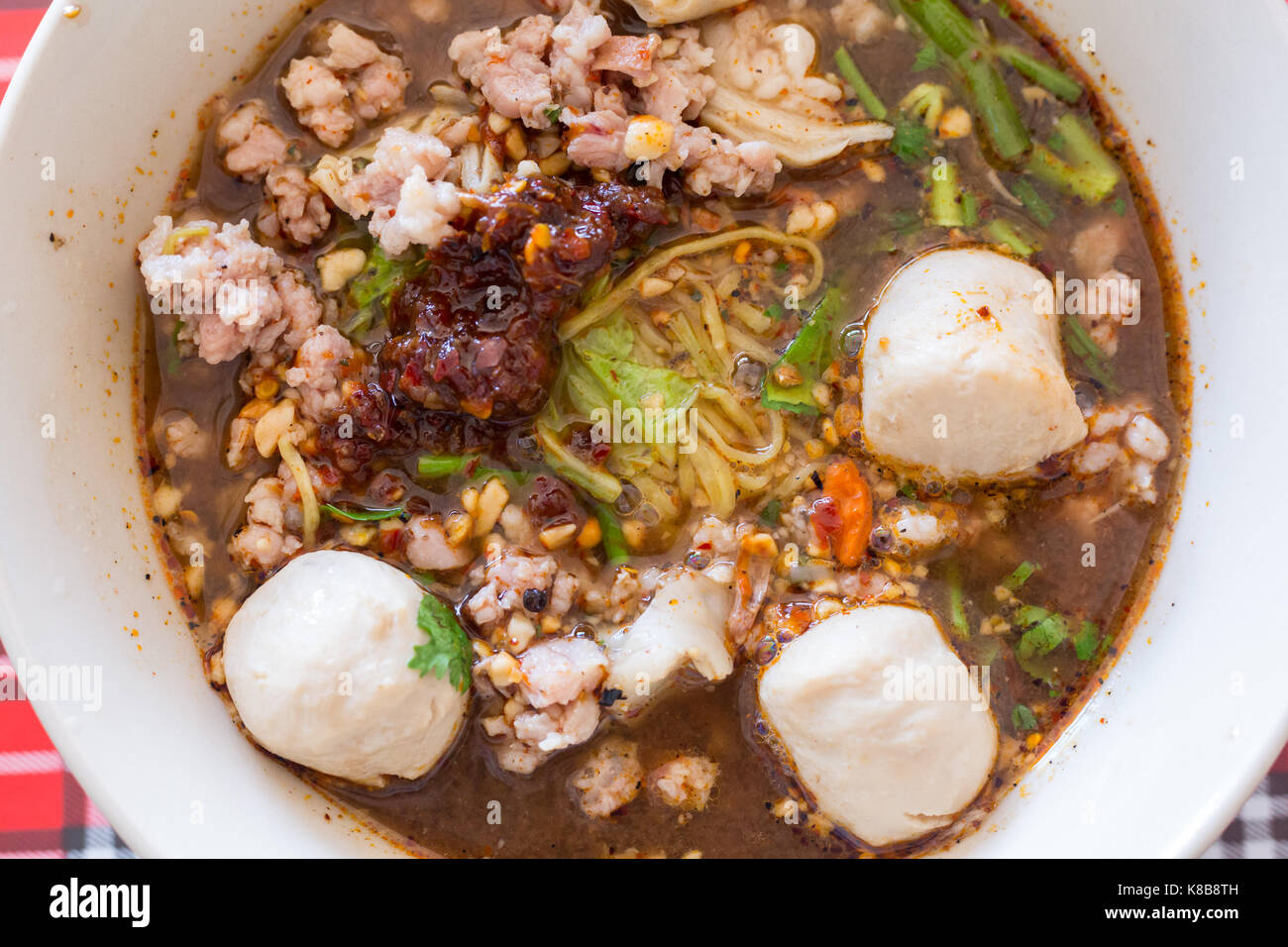 Spicy TOM YAM pork noodle soup with lemongrass, chilly pasted and lime juice Stock Photo