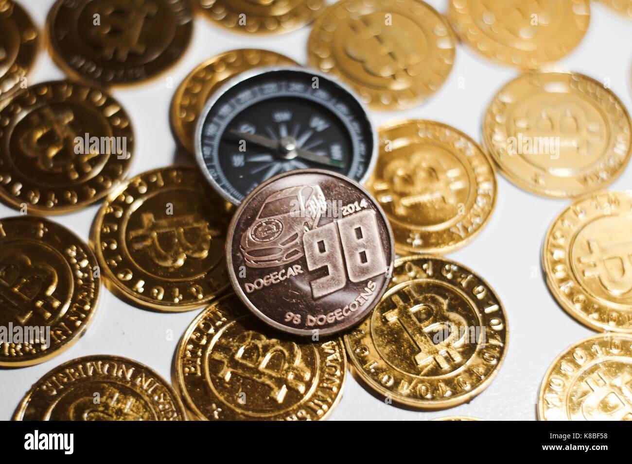 Cryptocurrency physical brass doge coin on the gold bitcoins. Compass  concept Stock Photo - Alamy