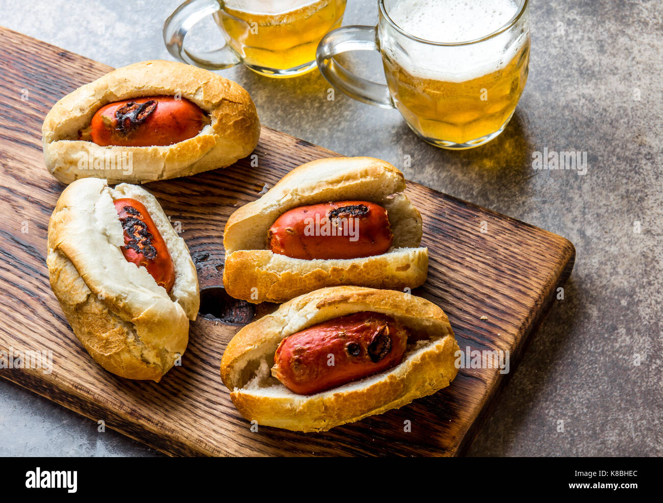 Choripan. Latin American Argentine and chilean food. Chorizo sausages hot dogs served with beer, top view. Stock Photo