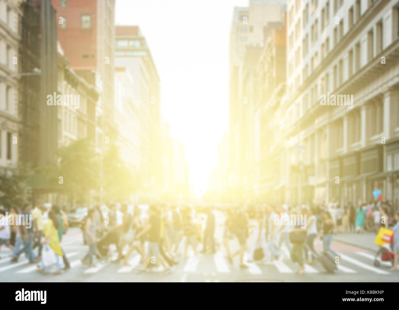 Crowds of people crossing a busy street in New York City with the light ...