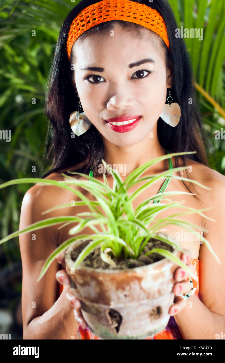 Young Asian woman holding pot plant Stock Photo - Alamy
