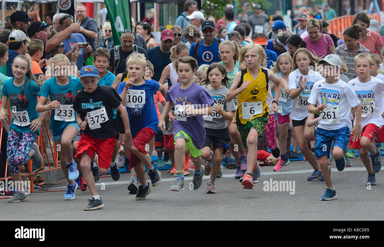 Young racers take flight at the start of the Kids Race during the Pearl Street Mile. The children and adolescents ran a half-mile course. Stock Photo
