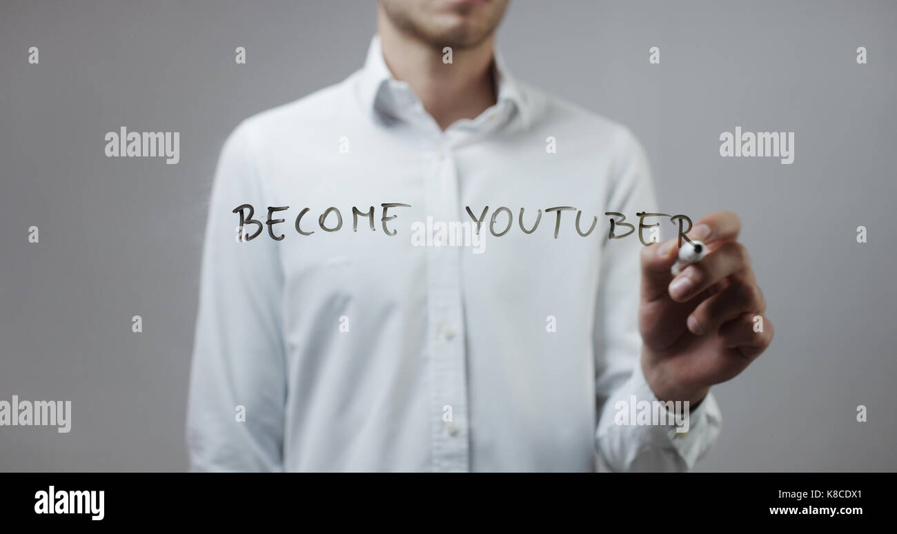 Become youtuber , Man Writing on Glass Stock Photo