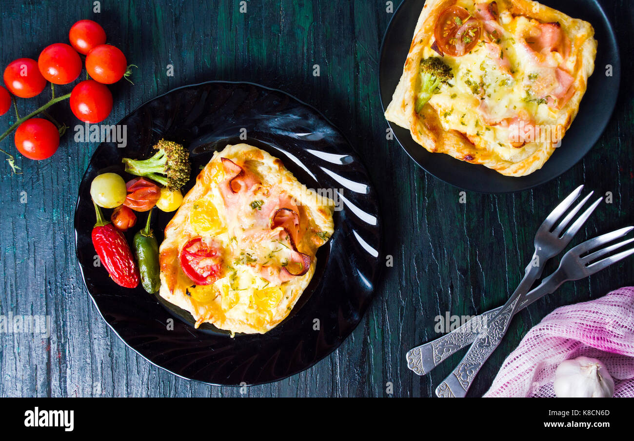 Homemade baked pizza sandwiches on a plate Stock Photo