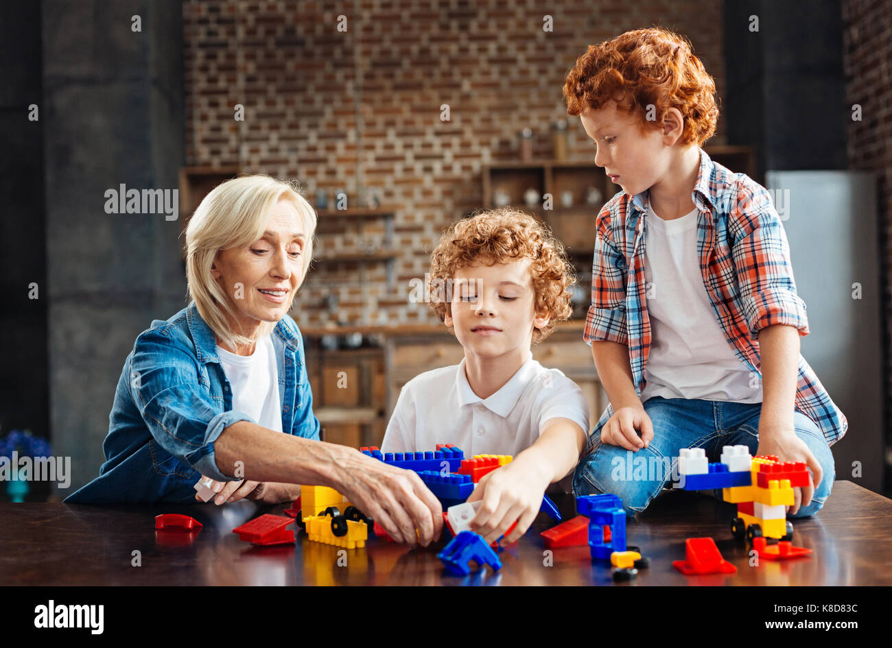 Loving grandmother playing with kids at home Stock Photo