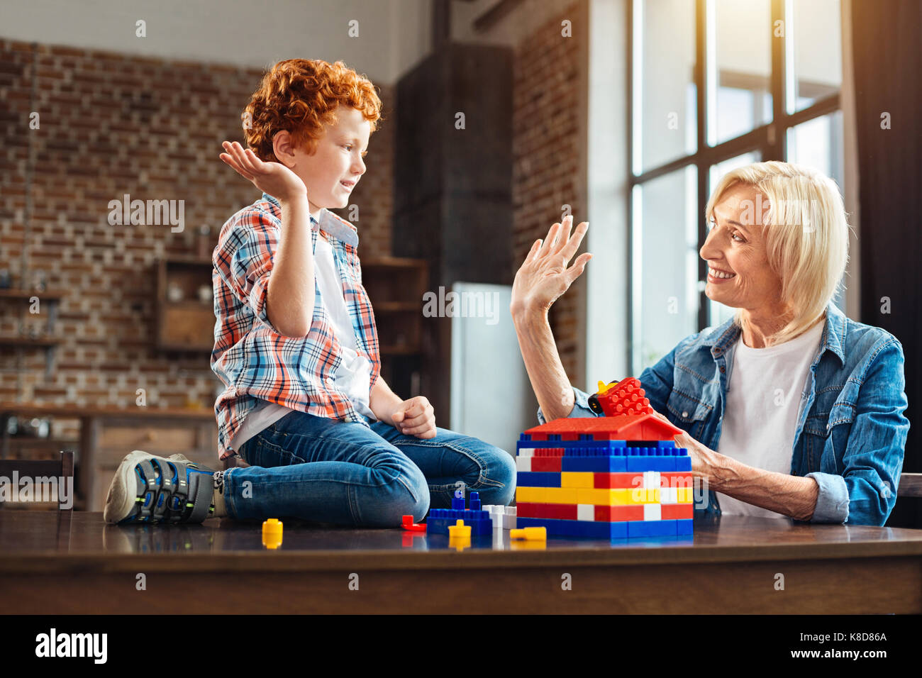 Cheerful family members high fiving while playing together Stock Photo