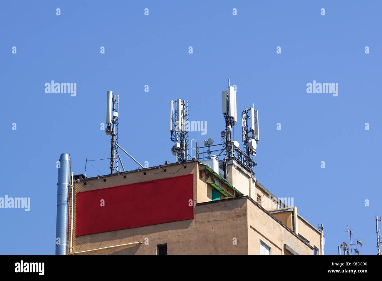 GSM transmitters on a roof of white administrative building. Close up Stock Photo
