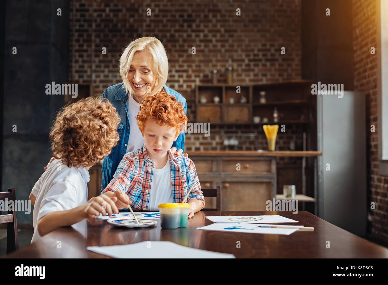 Radiant elderly lady listening to grandson at home Stock Photo - Alamy