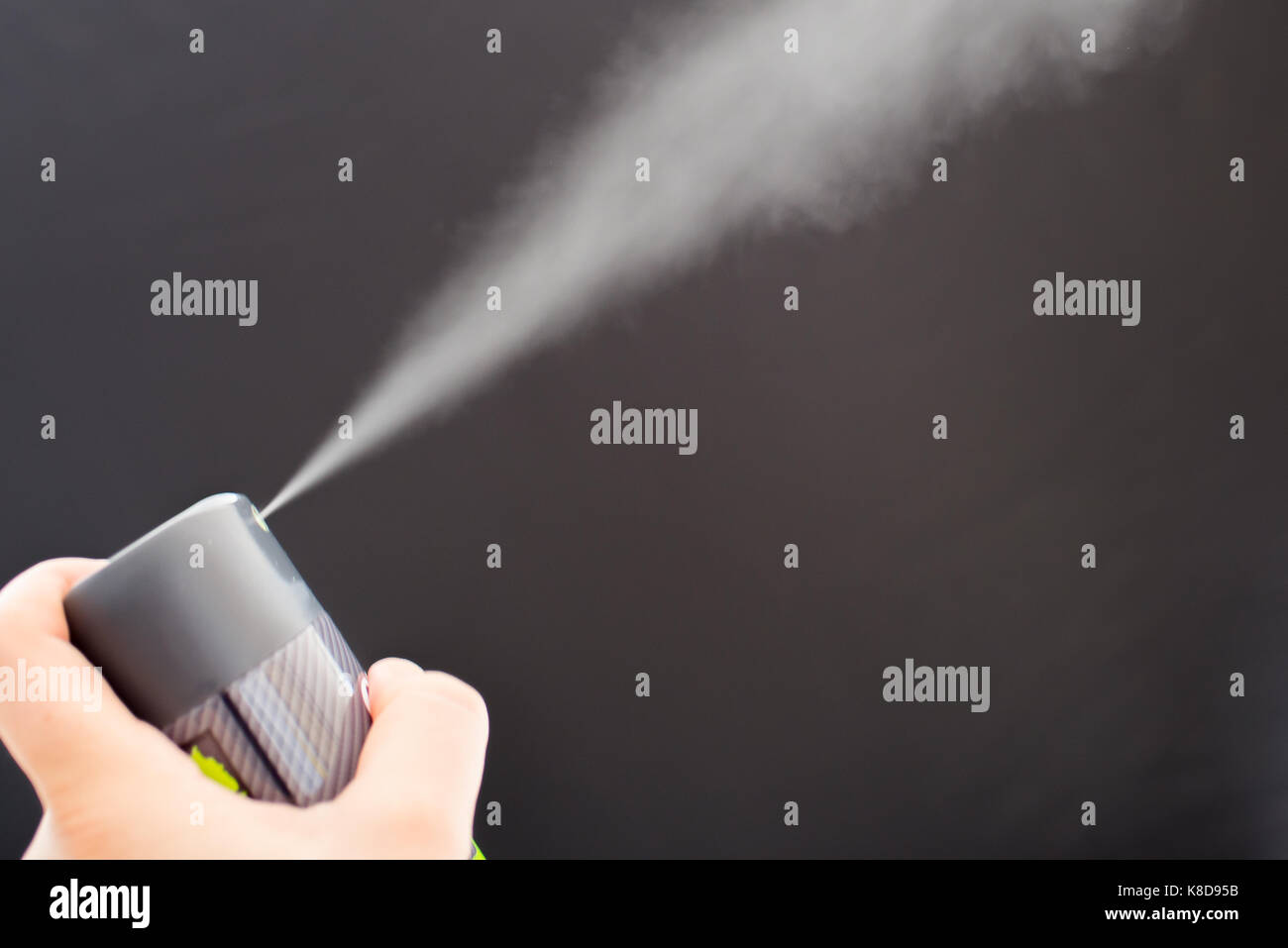 Deodorant can spraying on black background Stock Photo Alamy