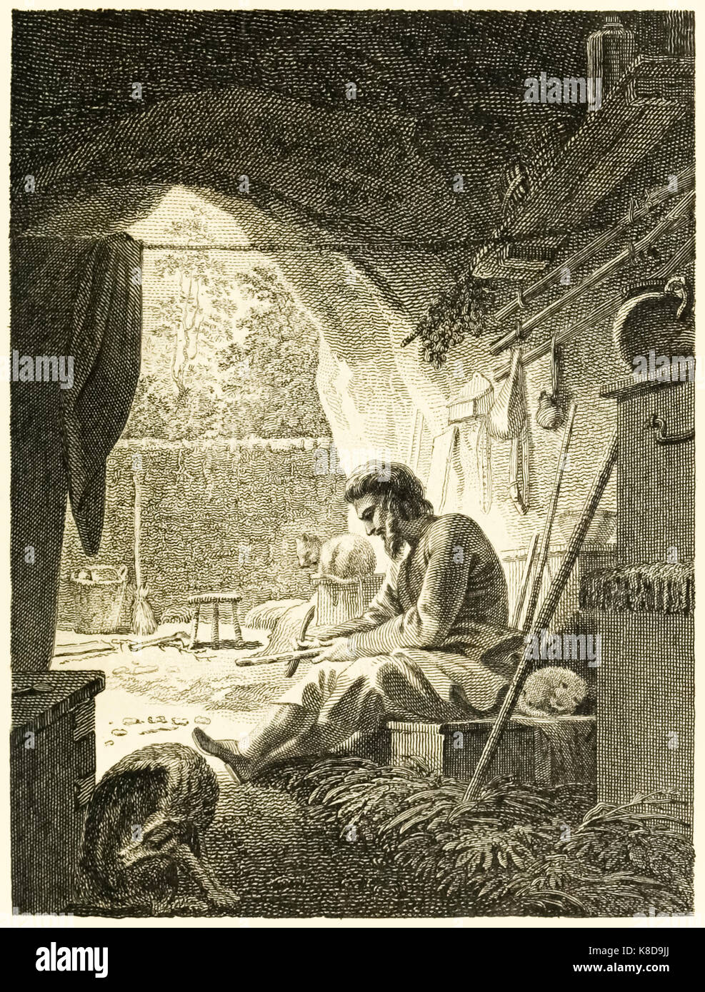 ‘Robinson Crusoe at work in his cave’ from “The Life and Strange Surprising Adventures of Robinson Crusoe, or York, Mariner” by Daniel Defoe (1660-1731). Illustration by Thomas Stothard (1755-1834) engraving by Thomas Medland (1765-1833). See more information below. Stock Photo