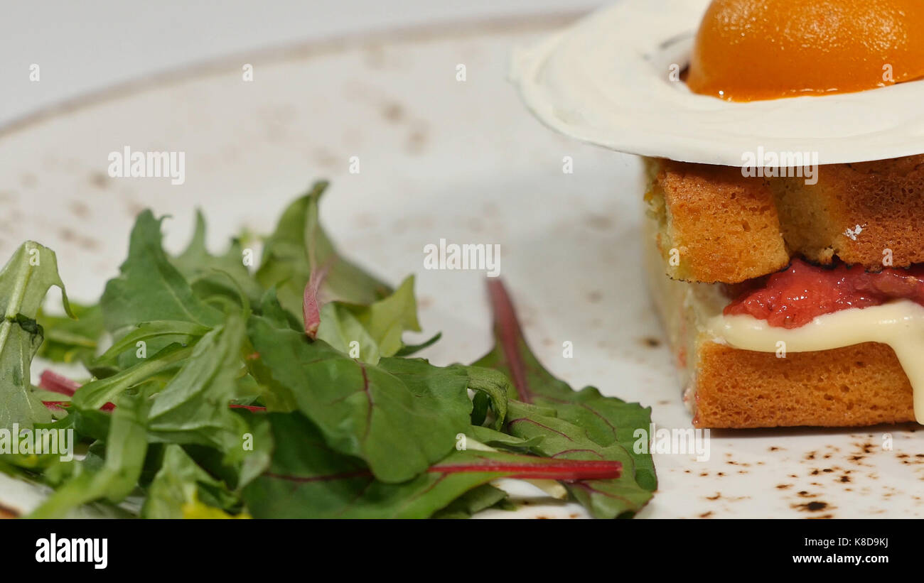 Sponge cake with strawberries, jam and whipped cream with a cut out