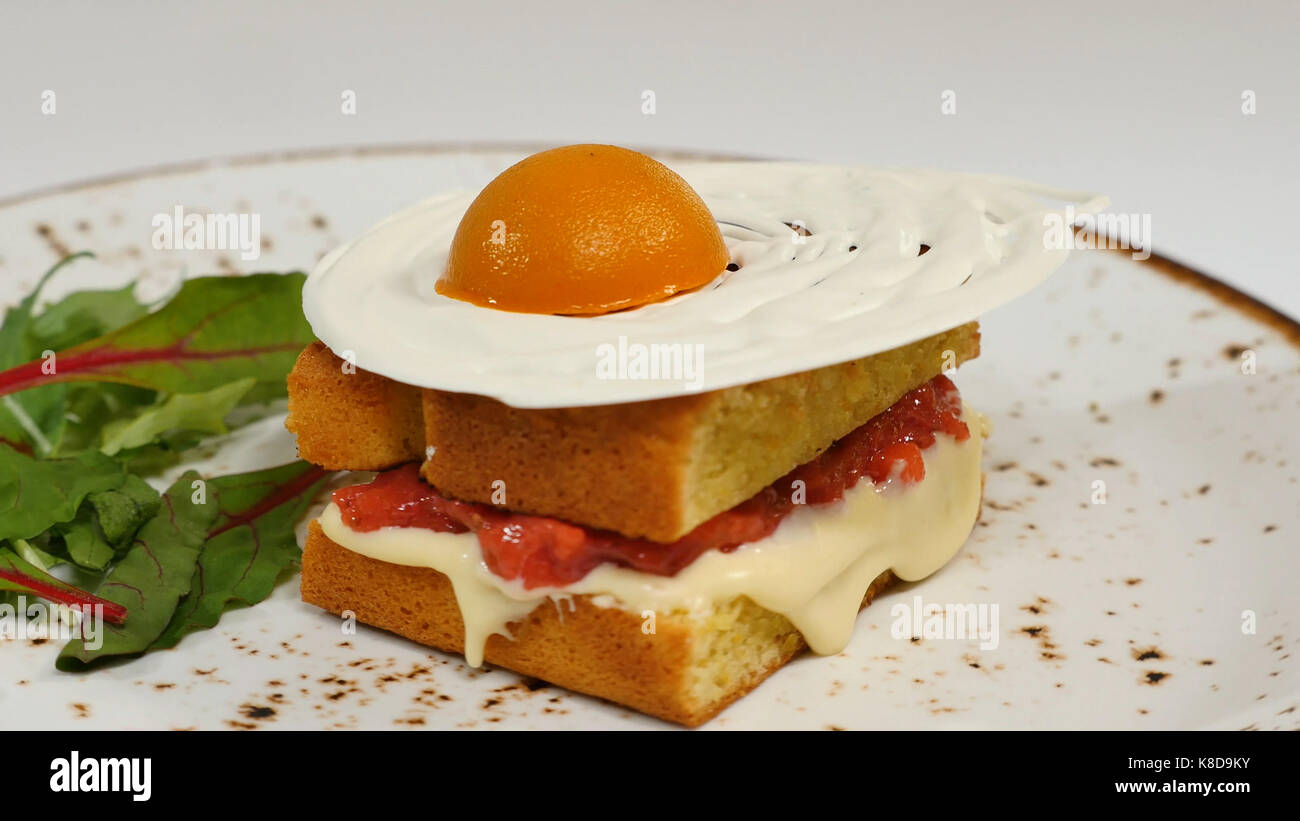 Sponge cake with strawberries, jam and whipped cream with a cut out