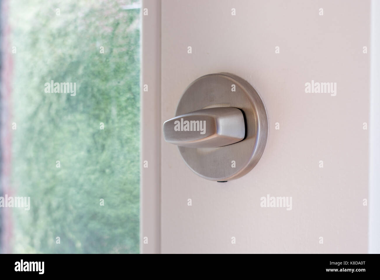A metal lock on white wooden door close up Stock Photo - Alamy