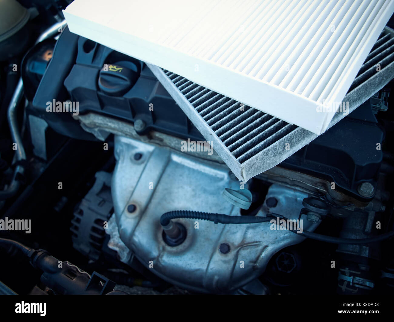New and old air filters on a car engine. Stock Photo