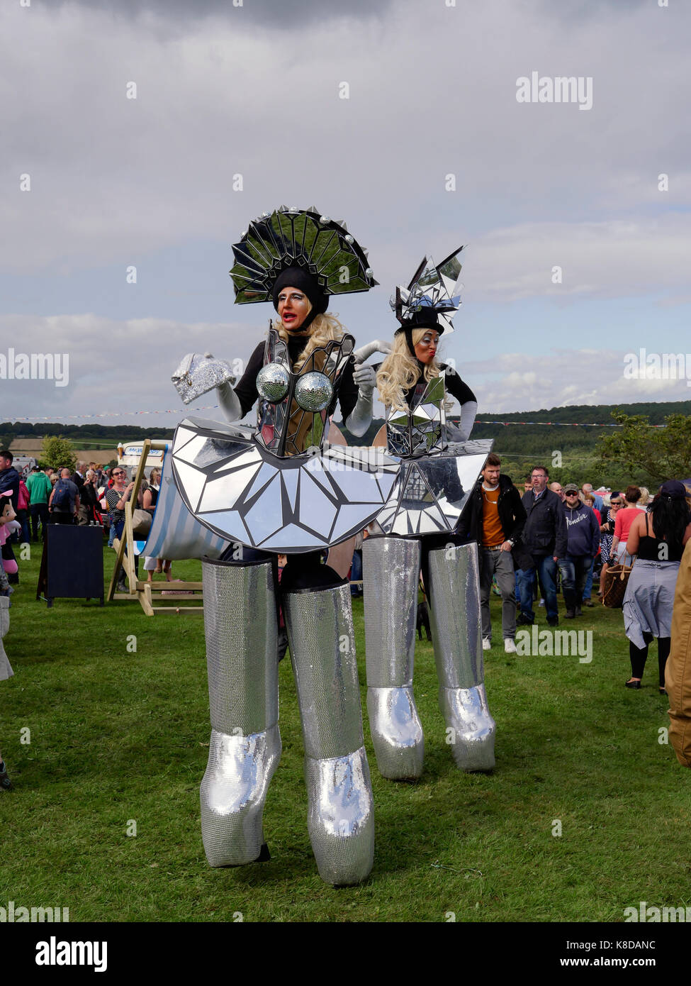 People on stilts Barlow street carnival parade in Derbyshire England