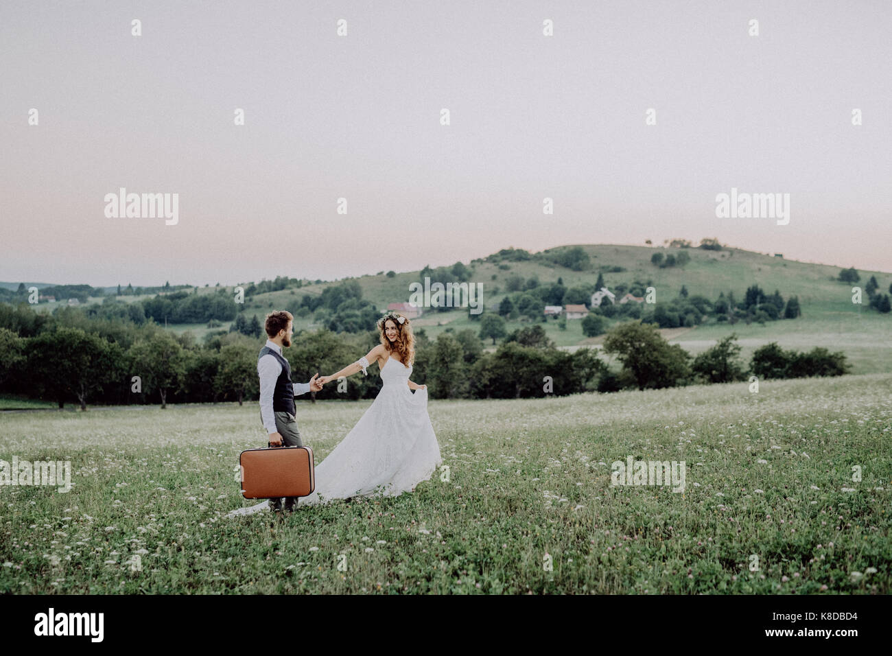 Beautiful bride and groom at sunset in green nature Stock Photo - Alamy