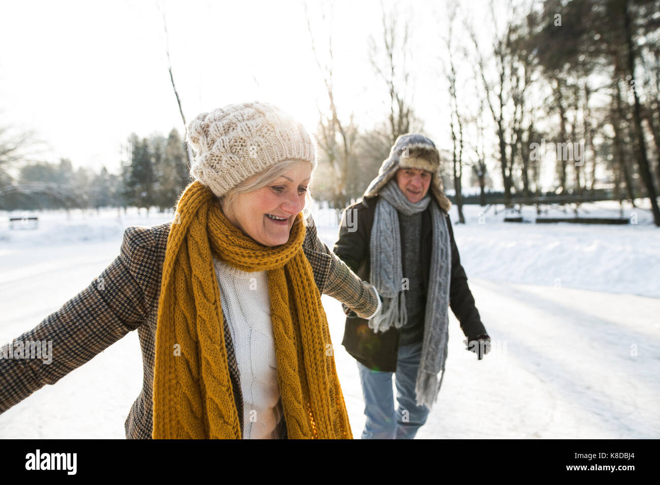 Senior couple in sunny winter nature ice skating. Stock Photo