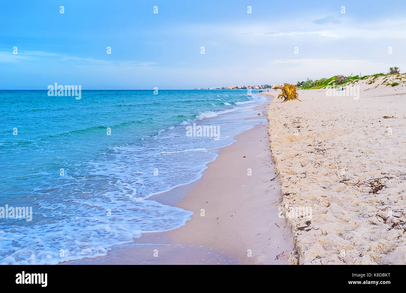 The sandy coast of El Kantaoui is the best place to relax and walk along the sea, enjoying the sunset, Tunisia. Stock Photo