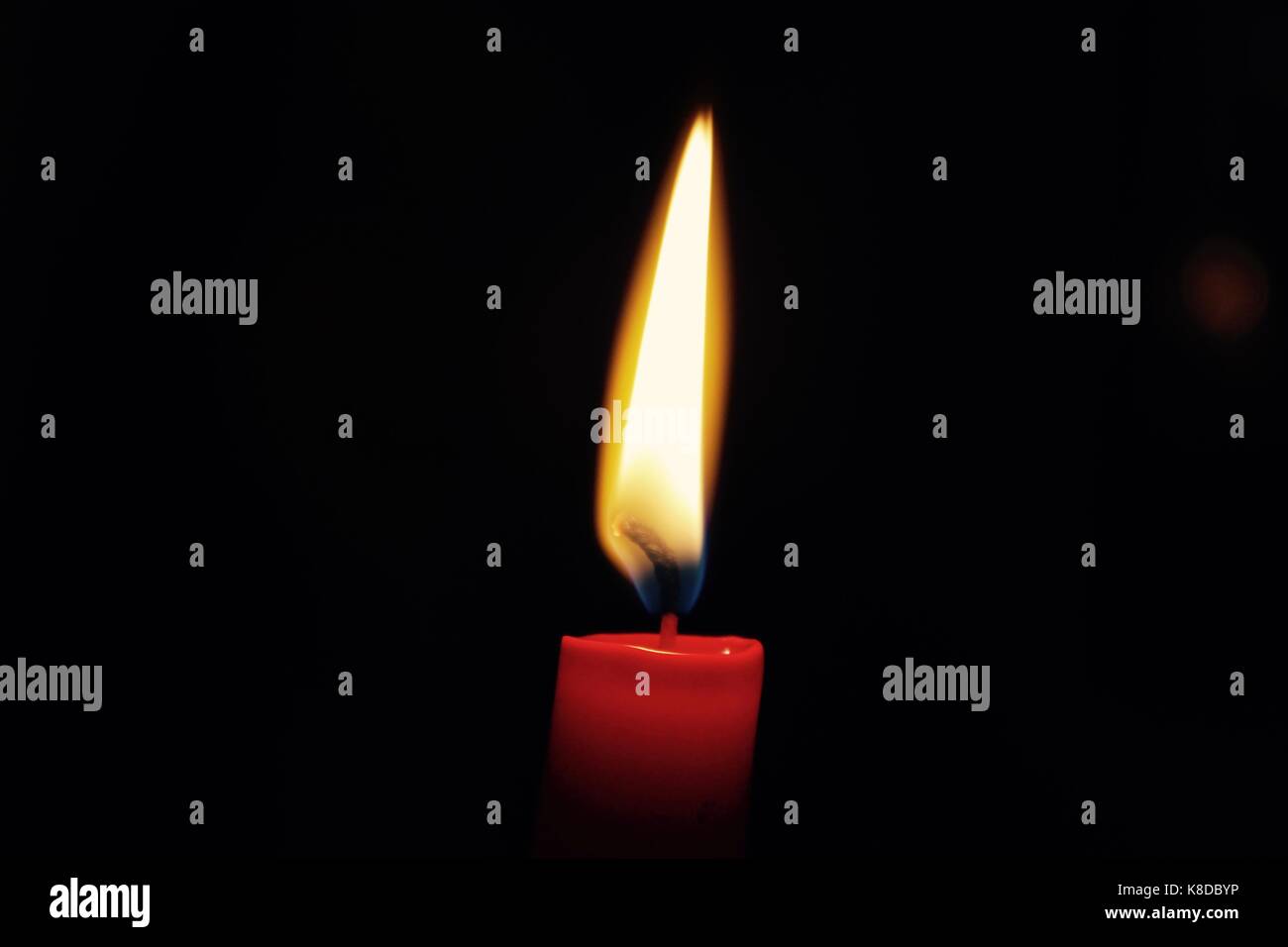 Burning red candle Stock Photo Alamy