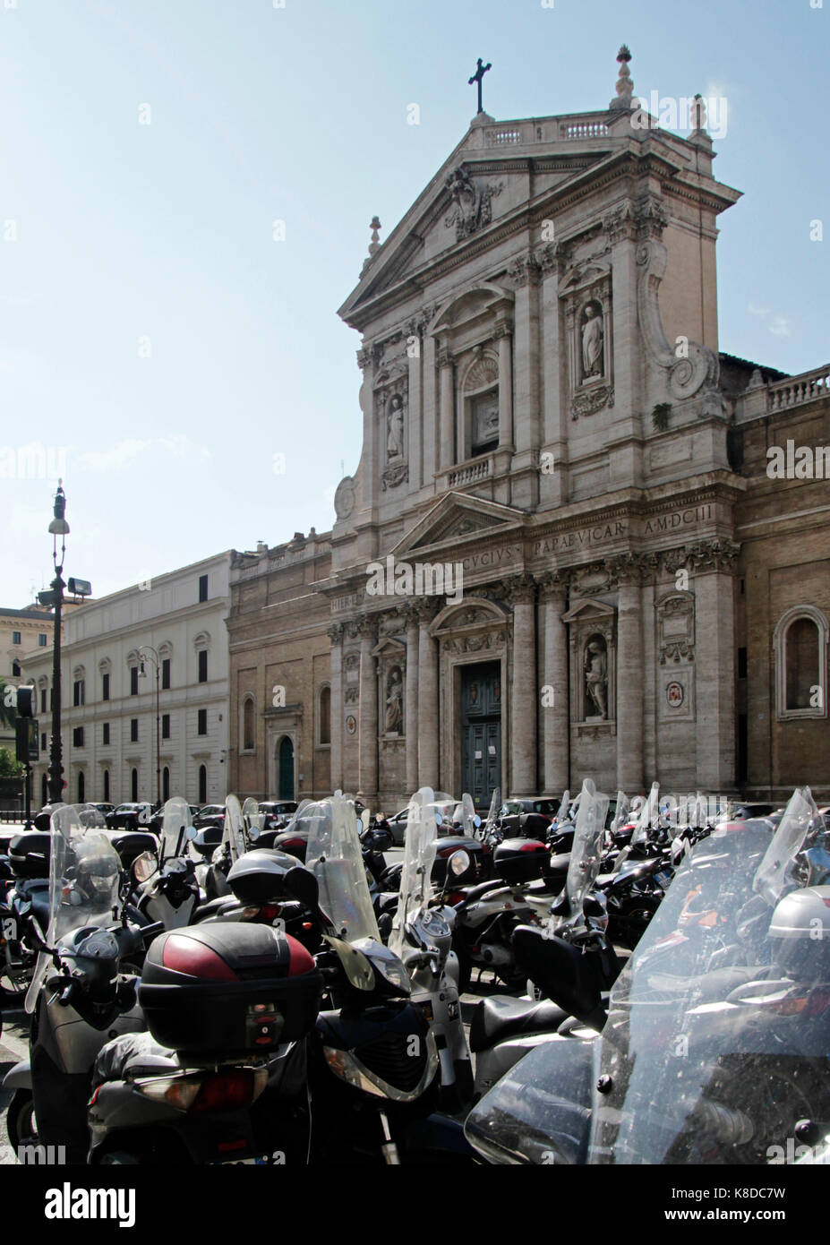 Moped Rome Many mopeds crowding the street in front of a building in Rome, Italy ...