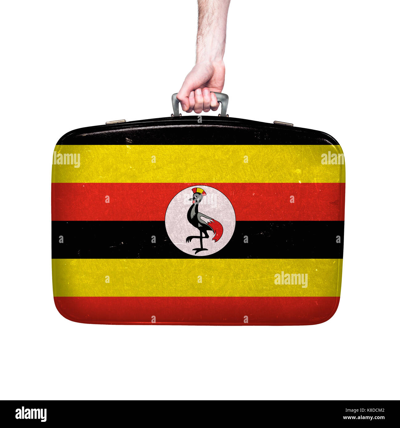 Uganda flag on a vintage leather suitcase. Stock Photo