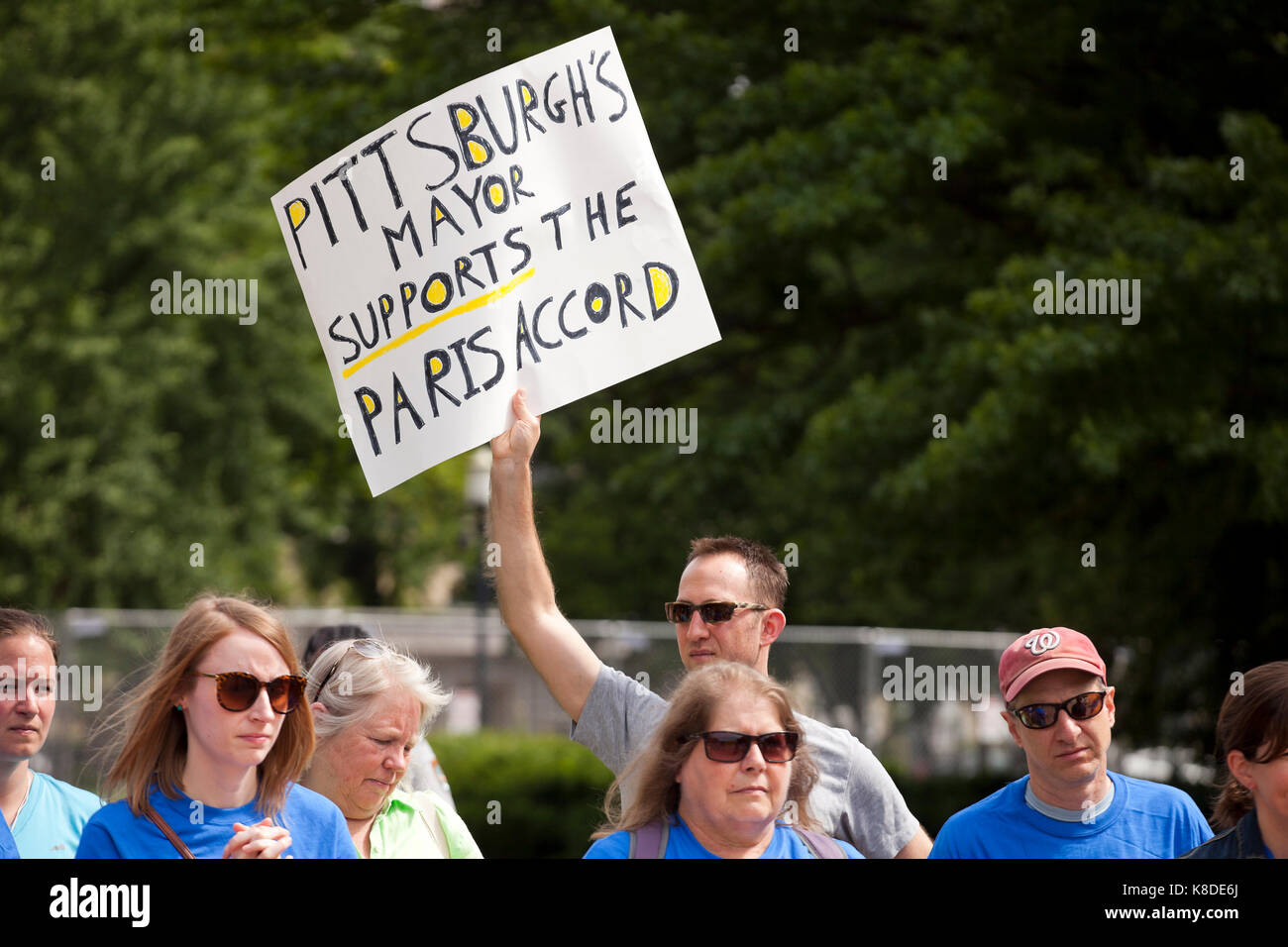 Climate change activist holding sign which reads 'Pittsburgh's Mayer Supports the Paris Accord' - Washington, DC USA Stock Photo